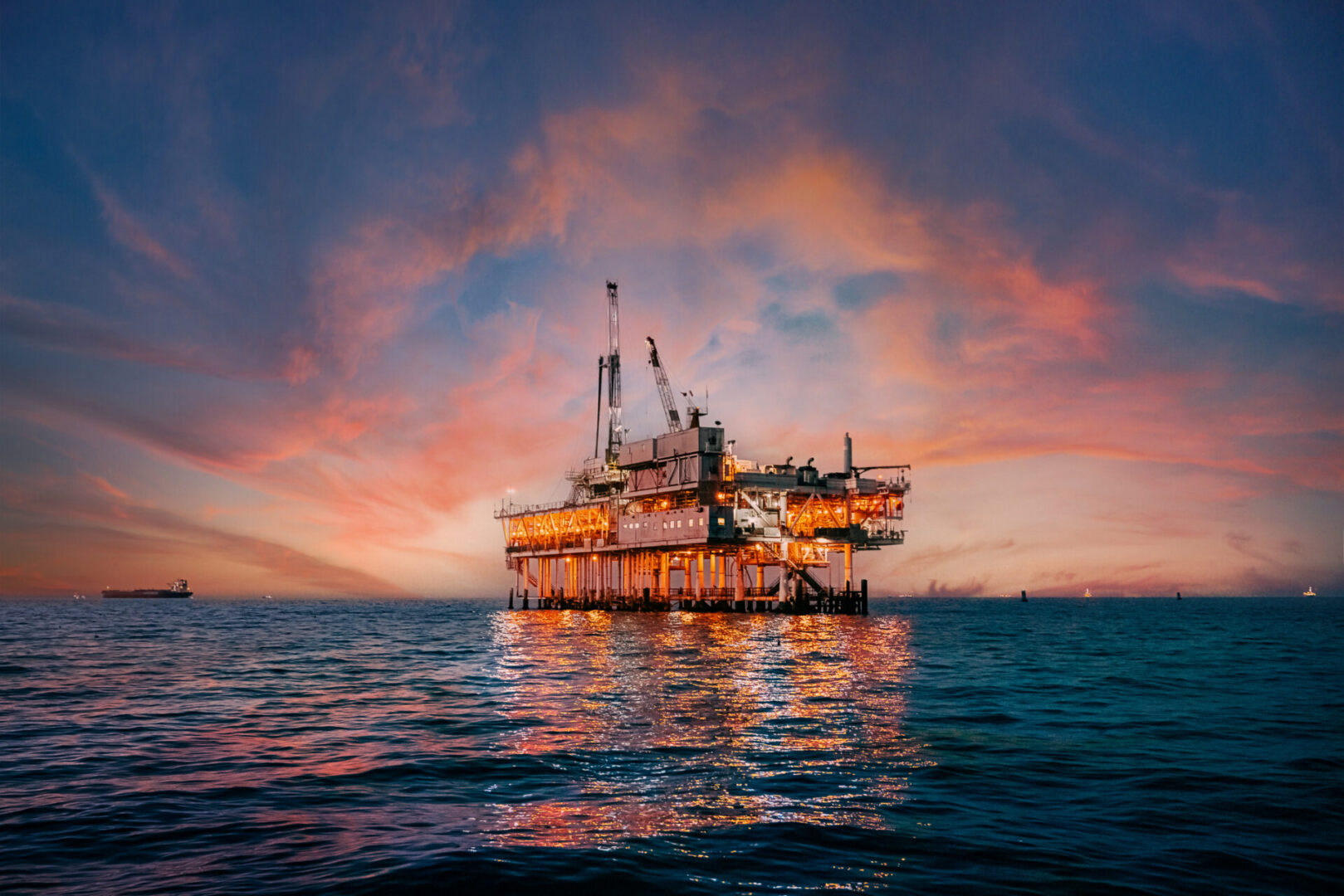 Offshore oil platform illuminated at sunset