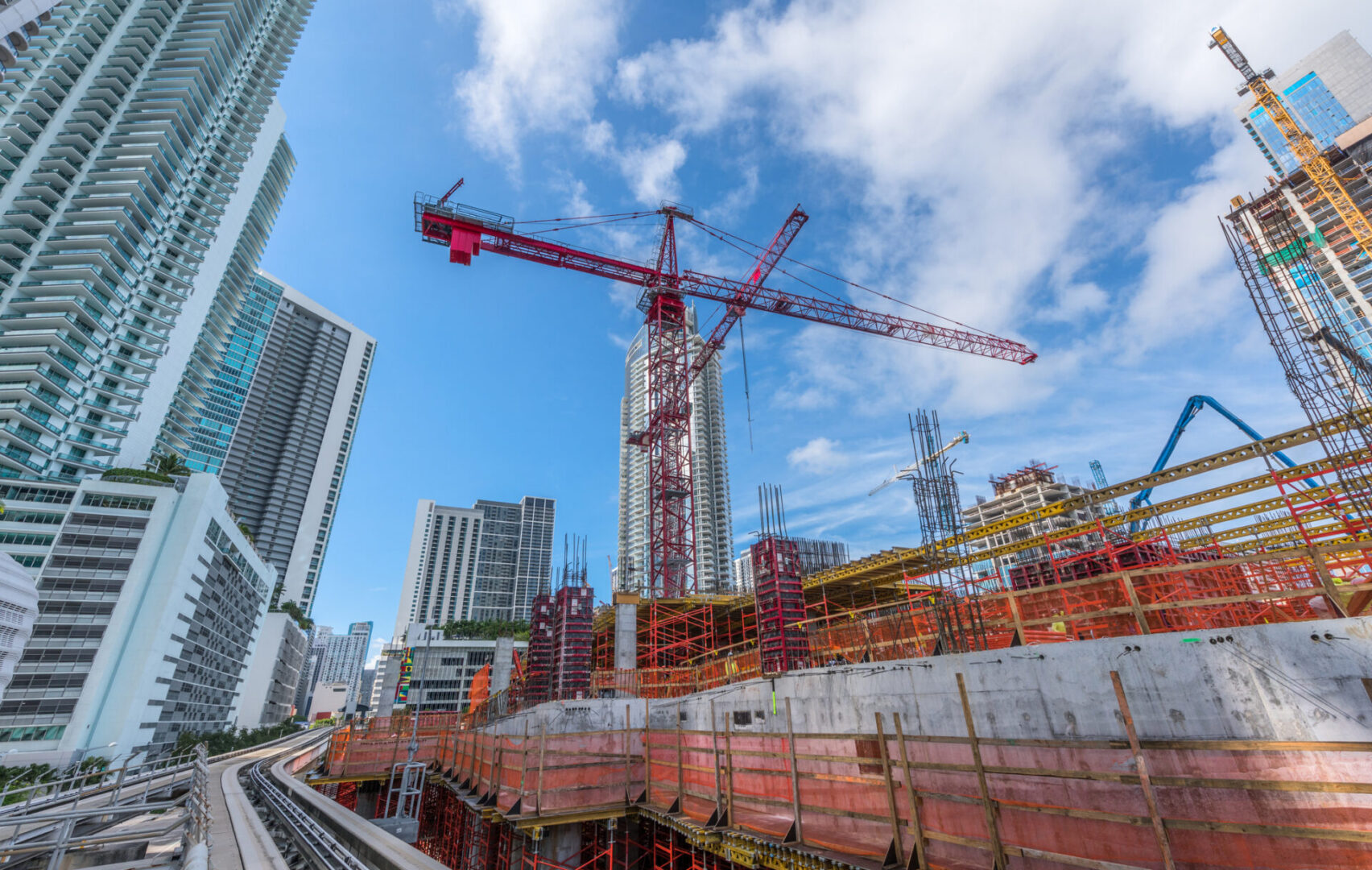 Urban construction site with red tower crane